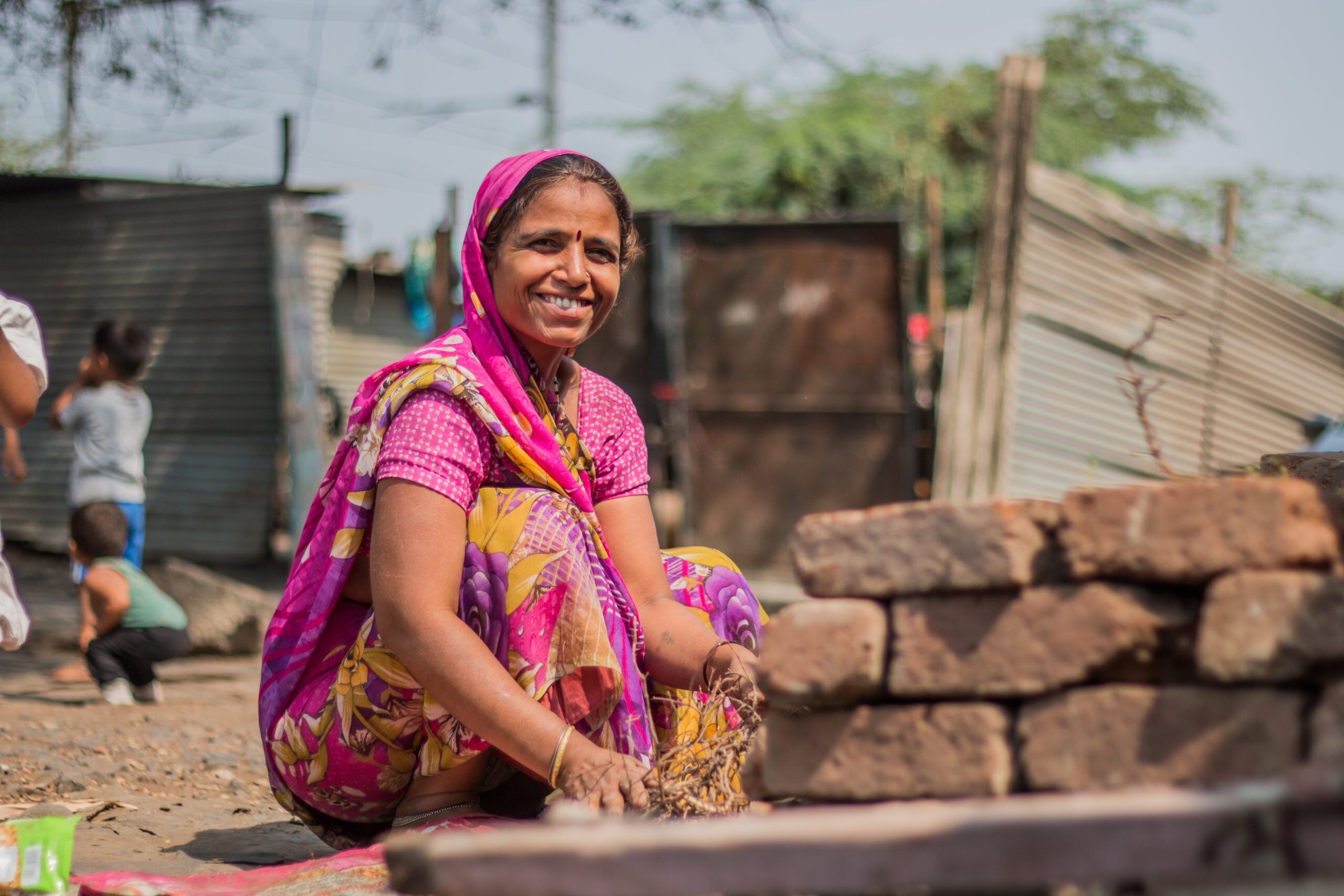 Woman sitting outdoors in a rural community in India