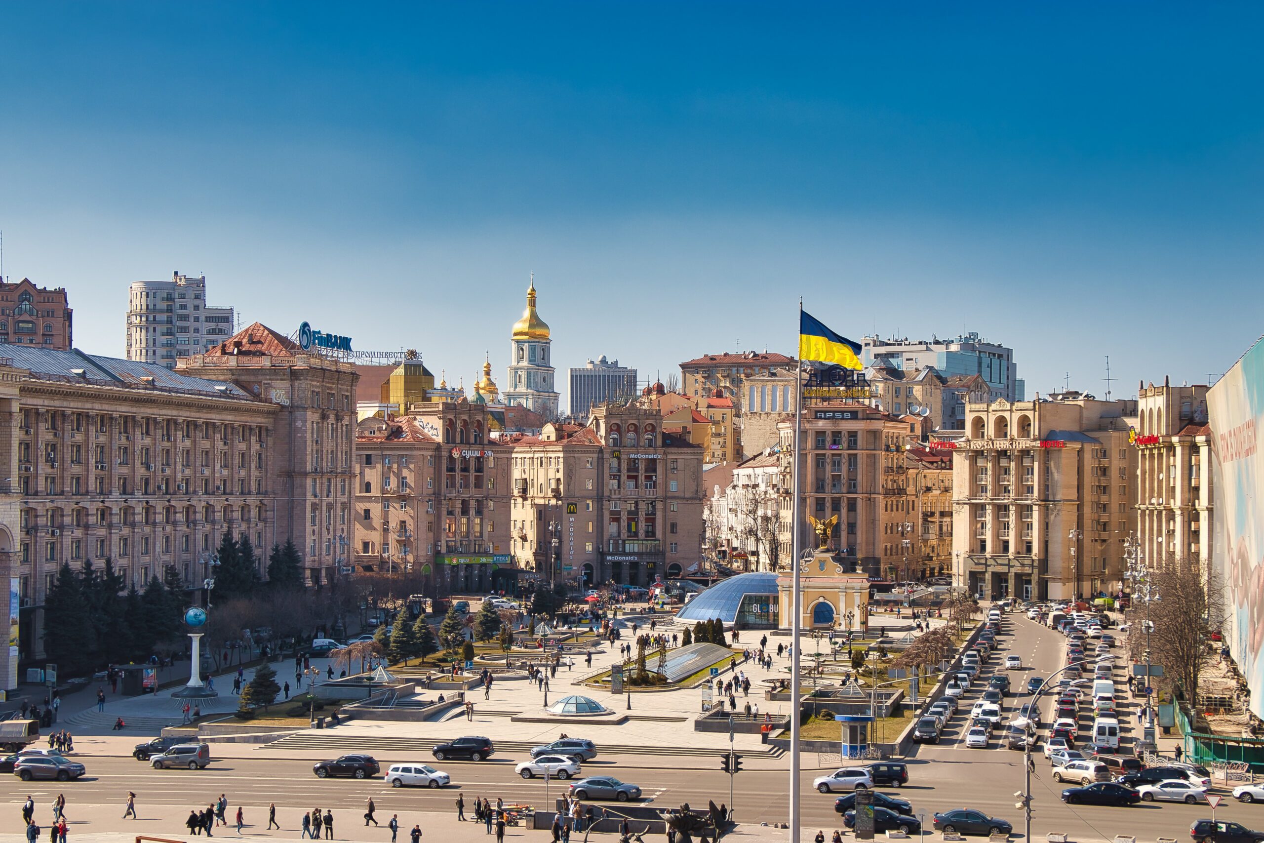 Central Kyiv cityscape with a Ukrainian flag flying over the square