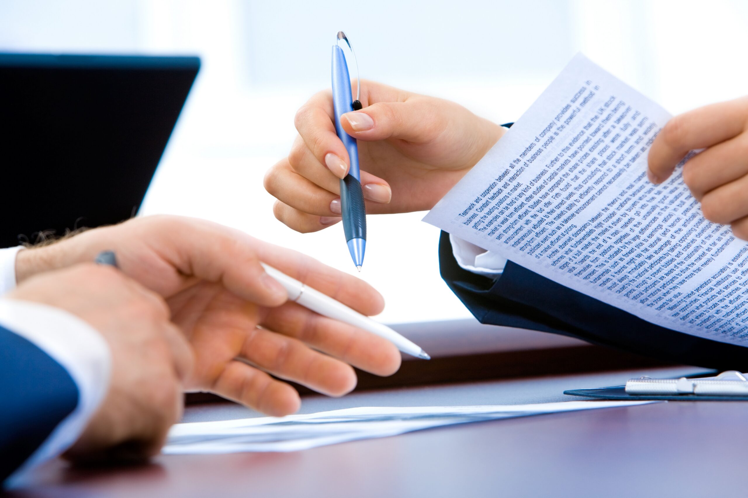 People reviewing documents together, representing support to strengthen financial procedures, controls and governance for a UK charity.